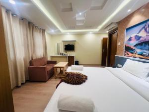Una habitación de hotel con una cama y una sala de estar. en Hotel Nirakar, en Katmandú 37 fotos más