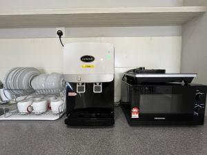 a coffee machine sitting next to a coffee maker at RiverView 8PAX 3BR in KBtown Wi-Fi, B-12-2 in Kota Bharu