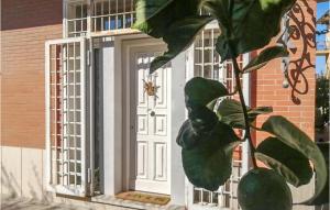 Un cuadro de una puerta blanca con hojas verdes. en Andry House Casa Vacanze, en Roma