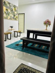 a living room with a bench and a table at Golf Avenue Homestay Kota Bharu in Pengkalan Cepa
