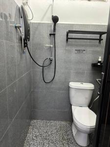 a bathroom with a shower with a toilet in it at Golf Avenue Homestay Kota Bharu in Pengkalan Cepa +6 photos