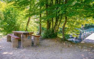 a wooden bench sitting next to a fence and trees at 1 Bedroom Nice Home In Lukezi in Lukeži +23 photos