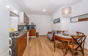 a kitchen and dining room with a table in a room at 1 Bedroom Nice Home In Lukezi in Lukeži