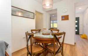 a dining room with a table and chairs at 1 Bedroom Nice Home In Lukezi in Lukeži