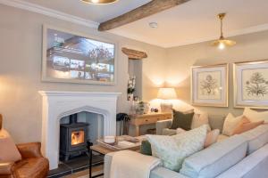 a living room with a couch and a fireplace at Danes Cottage - Luxury Peak District Retreat in Chapel en le Frith