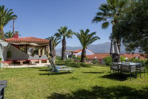 a park with palm trees and a playground with a swing at Studios Rania - Rania Studios & Apartments in Lassi