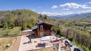 an aerial view of a house on a hill at Vivi la Magia di Bisdalù - Dormi nella Stanza nel Bosco, Ammira le Stelle e Rilassati con l'Area Benessere e Colazione in Peveragno