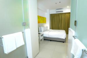 Rúm í herbergi á Go Hotels Timog