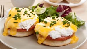 two egg sandwiches with cheese and vegetables on a plate at Adaaran Club Rannalhi - All Inclusive - 45 Minutes away from Male by Speedboat in South Male Atoll