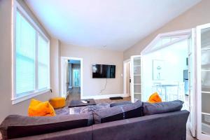 a living room with a couch and a tv at The Loft at Gilpin PlaceKing BedTrolley Square! apts in Wilmington