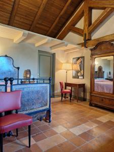 a room with a bed and a table and chairs at Tenuta Montanello B&B in Castiglione Falletto