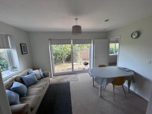 a living room with a couch and a table at Hamble House Holiday Let in Woodbridge +9 photos