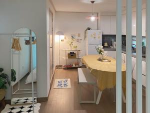 a small kitchen with a table and a refrigerator at TheComma in Seoul