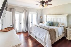 a bedroom with a bed and a ceiling fan at Stunning Riverside Retreat with Private Pool home in Port Vincent