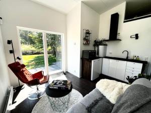 a living room with a couch and a table at Strandnära modernt gästhus in Stråvalla