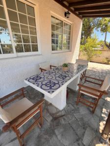 a table and chairs sitting on a patio at Aphaia Serenity Apartment in Egina