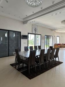 a large dining room with a table and chairs at Super belle villa avec piscine in Fez +27 photos