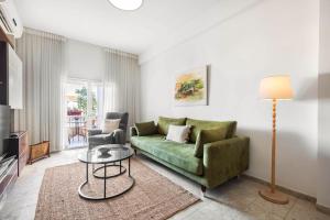 a living room with a green couch and a table at Ben Yehuda Elegant City Retreat with Shelter by Sea N Rent in Tel Aviv