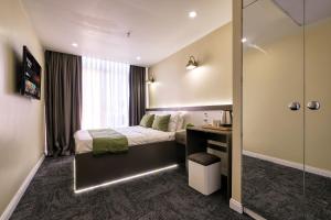 Ένα ή περισσότερα κρεβάτια σε δωμάτιο στο Duck Otel