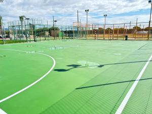 a tennis court with the shadow of a tennis racket at Cambrils Paradise in Cambrils
