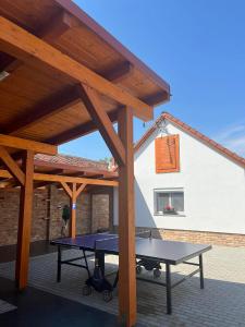 a picnic table under a pavilion on a patio at Ikervár-lak in Ikervár +23 photos