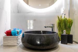 a large black bowl sink in a bathroom at Theo's Cozy Apartment's near Athens airport in Spáta +71 photos