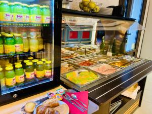 a refrigerator filled with lots of food and drinks at Logis Hôtel Restaurant Le Top du Roulier in Capendu +19 photos