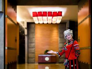 a woman in a costume standing in a hallway at Pullman Zhangjiajie Hotel - Instagrammable in Zhangjiajie