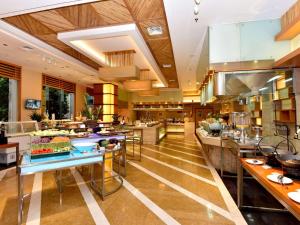 a large kitchen with a lot of food on display at Pullman Zhangjiajie Hotel - Instagrammable in Zhangjiajie