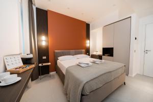 a bedroom with a bed and a table and a television at Ypnos Rooms in Naples