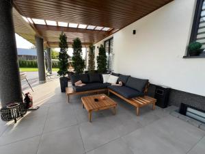 a patio with a couch and a coffee table at Kierunek Górki in Górki