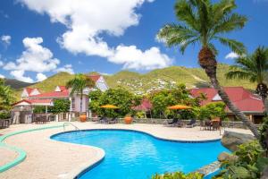 a resort with a swimming pool with a palm tree at Port de Plaisance Resort, Trademark Collection by Wyndham in Philipsburg