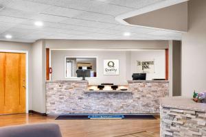 a lobby of a dental office with a stone counter at Quality Inn & Suites Gorham Riverside in Gorham
