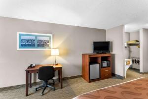 a hotel room with a desk and a television at Quality Inn & Suites Gorham Riverside in Gorham