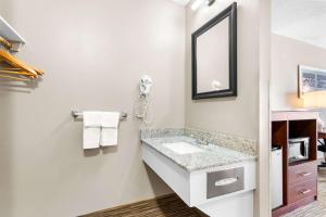 a bathroom with a sink and a mirror at Quality Inn & Suites Gorham Riverside in Gorham