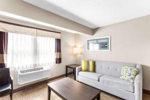 a living room with a couch and a table at Quality Inn & Suites Gorham Riverside in Gorham