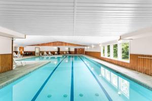 a large indoor swimming pool with blue water at Quality Inn & Suites Gorham Riverside in Gorham