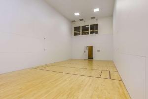 an empty room with a wooden floor and white walls at Quality Inn & Suites Gorham Riverside in Gorham