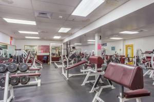 a gym with a lot of treadmills and machines at Quality Inn & Suites in Gorham