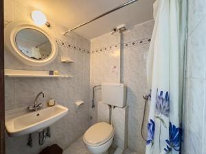 a bathroom with a toilet and a sink and a mirror at ΑΡΜΕΝΙΣΤΗΣ House for your vacation in Armenistis