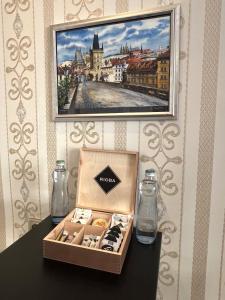 a box of cookies sitting on a table with two glass bottles at Romance in the Old Town in Prague