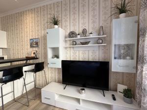 a living room with a flat screen tv on a wall at Romance in the Old Town in Prague