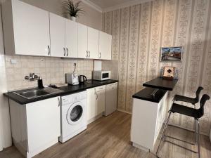 a kitchen with a sink and a washing machine at Romance in the Old Town in Prague