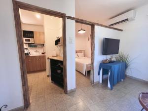 a room with a mirror and a table and a bed at הצימר של יהושע in Ein Gedi