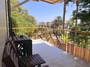 a porch with a bench and a view of a zoo at הצימר של יהושע in Ein Gedi