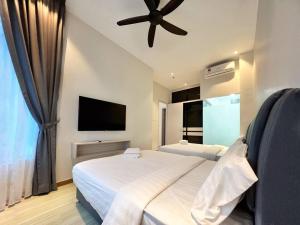 a bedroom with two beds and a flat screen tv at Melaka Penthouse 8-10 Pax 3 Rooms 3 Bathroom 2 Carparks in Malacca +2 photos