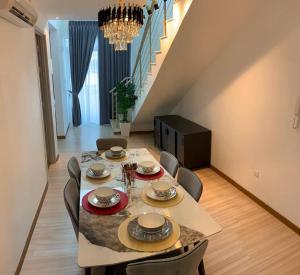 a dining room with a table and chairs and a staircase at Melaka Penthouse 8-10 Pax 3 Rooms 3 Bathroom 2 Carparks in Malacca