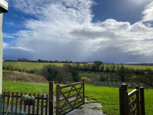 a wooden fence with a field in the background at Annies in Okehampton