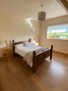 a bedroom with a bed and a window at Annies in Okehampton