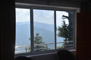 Una ventana con vista a la montaña. en Mountain View Guest House by LMC, en Nathia Gali